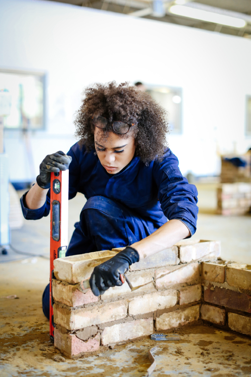 Student working with cement and bricks